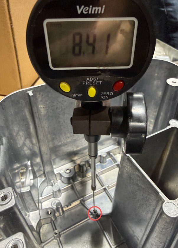 Dial indicator reading 8.41 mm on the die cast boss