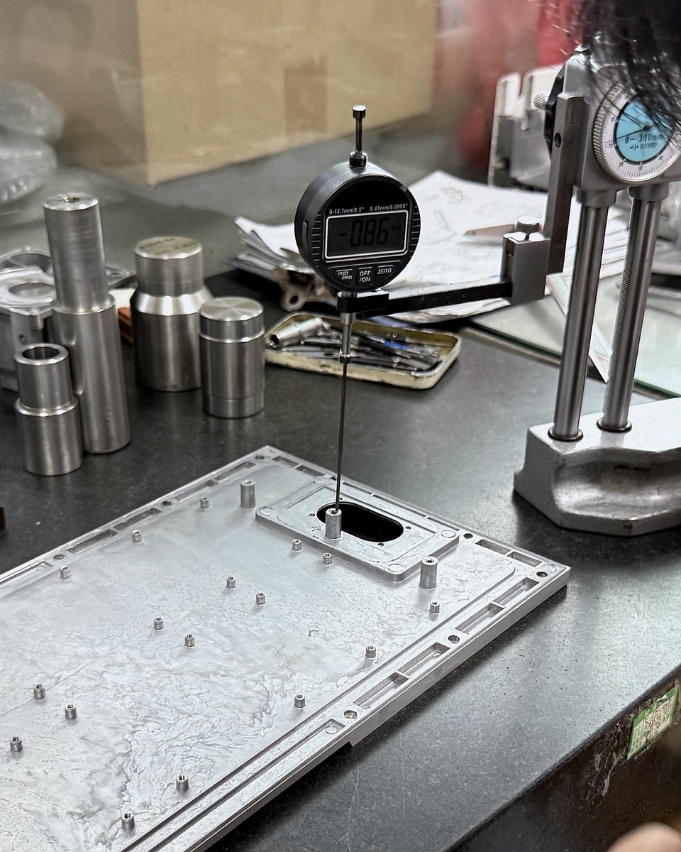 Dial indicator inspection of a die-cast aluminum part on the SunOn QC bench