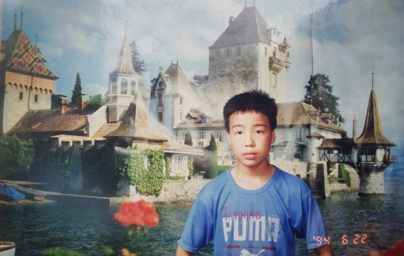1994 portrait against a painted castle backdrop at a town photo studio