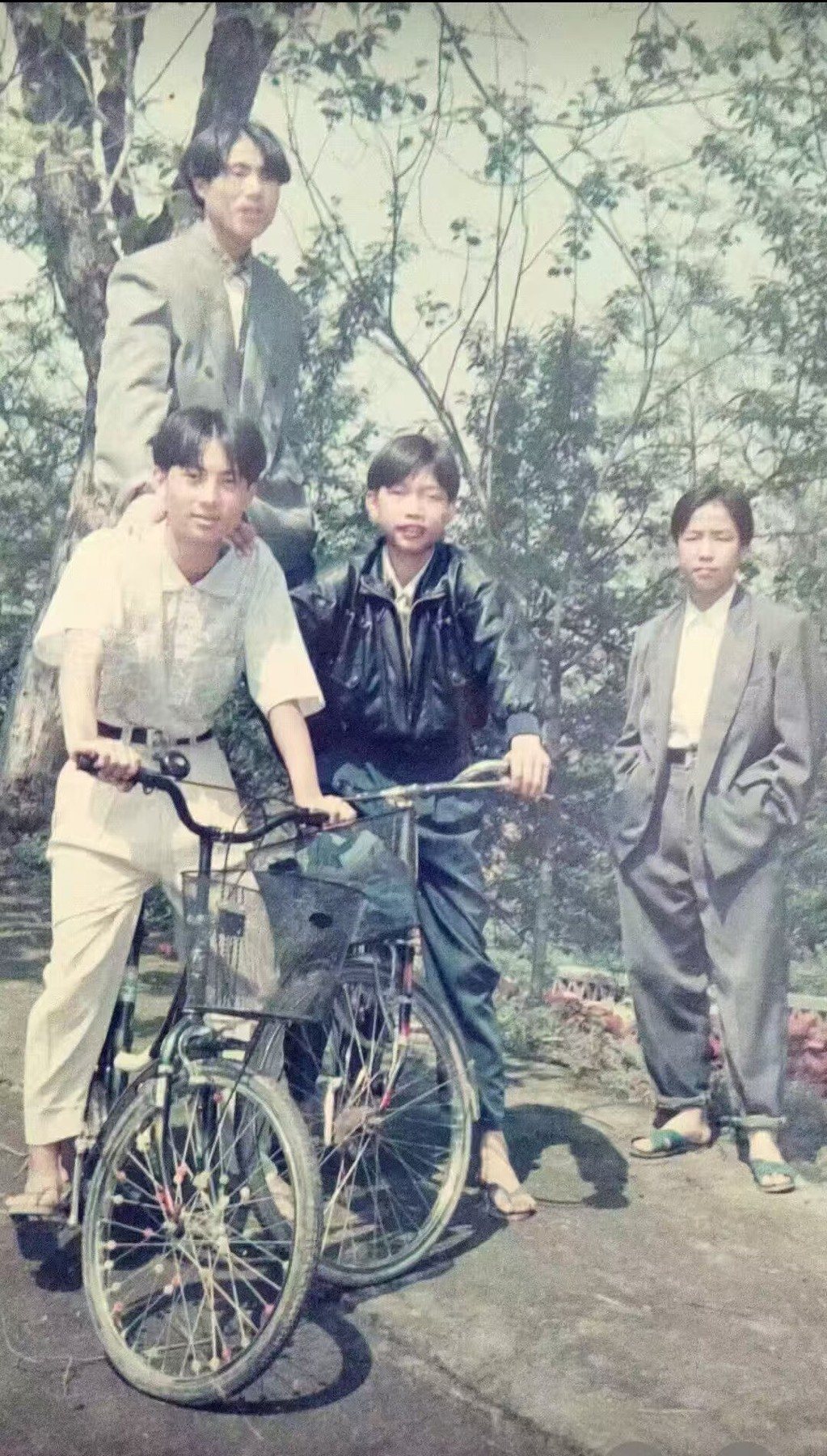 Middle-school years, standing with a bicycle